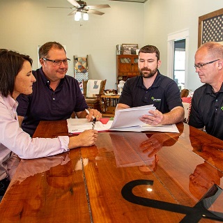 Couple reviewing paperwork with lenders.