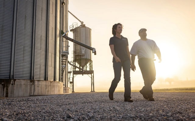 Farmer walking with his Farm Credit Mid-America Crop Insurance agent
