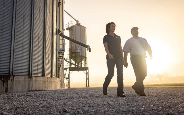 Farmer walking with his Farm Credit Mid-America Crop Insurance agent