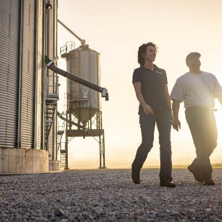 Farmer walking with his Farm Credit Mid-America Crop Insurance agent