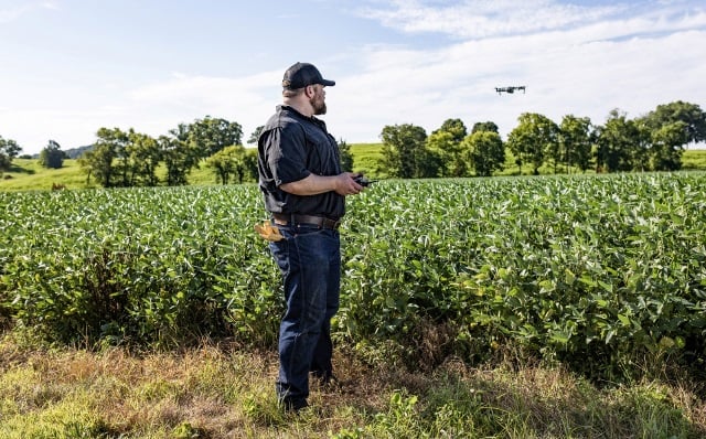 Farmer using drone financed by Farm Credit Mid-America.