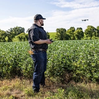 Farmer using drone financed by Farm Credit Mid-America.