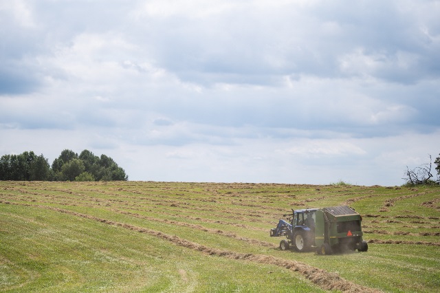 Tractor baling hay insured through PRF policy