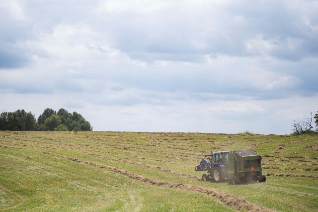 Tractor baling hay insured through PRF policy