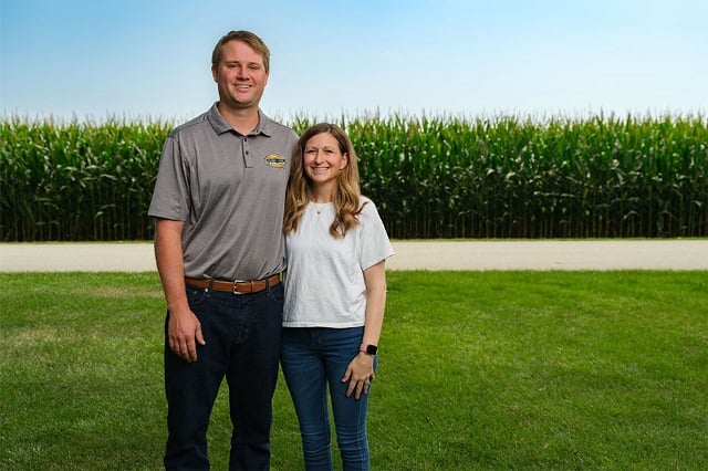 Josh and Kate Pottschmidt stand in front of popcorn field financed through Farm Credit Mid-America
