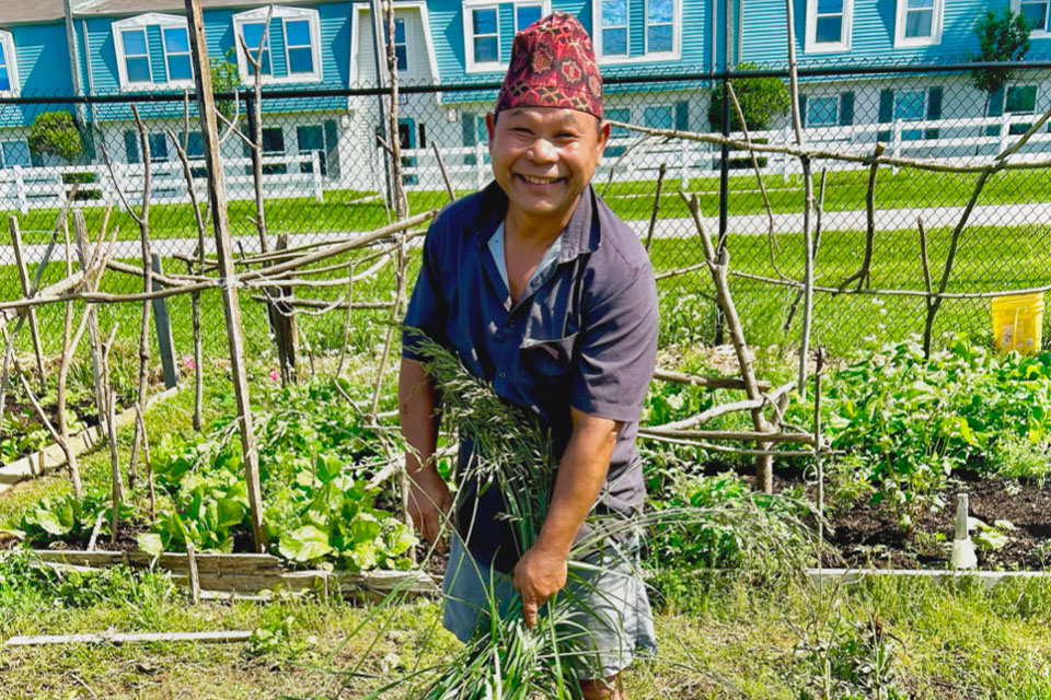 Refugee farmer on-site of Farm Credit Mid-America community partner.