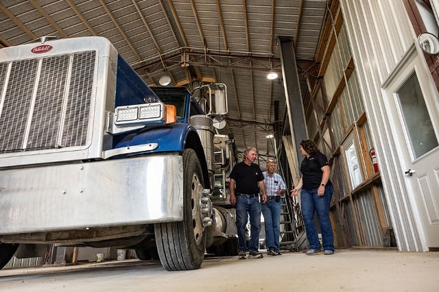 Customers discuss leasing program with Farm Credit Mid-America Financial Officer.