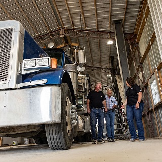 Customers discuss leasing program with Farm Credit Mid-America Financial Officer.