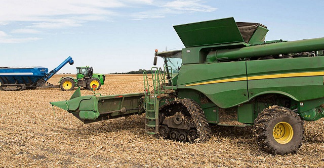 Combine and tractor funded through ag equipment financing by Farm Credit Mid-America.