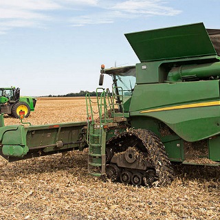 Combine and tractor funded through ag equipment financing by Farm Credit Mid-America.