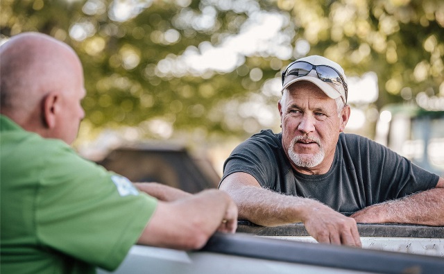 Two men talking.