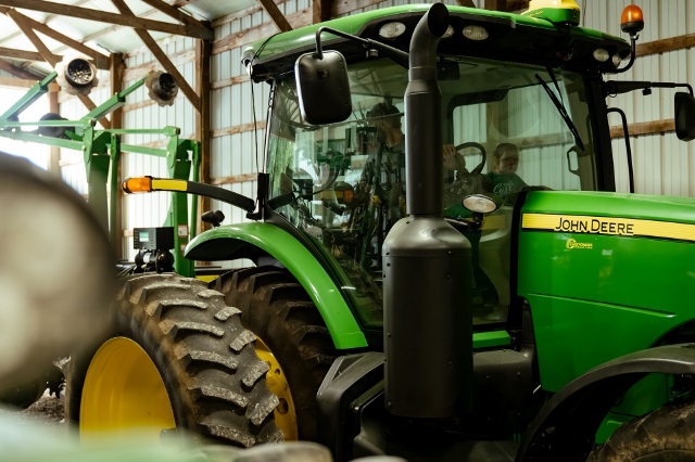 Farmer and his daughter in a tractor financed by Farm Credit Mid-America