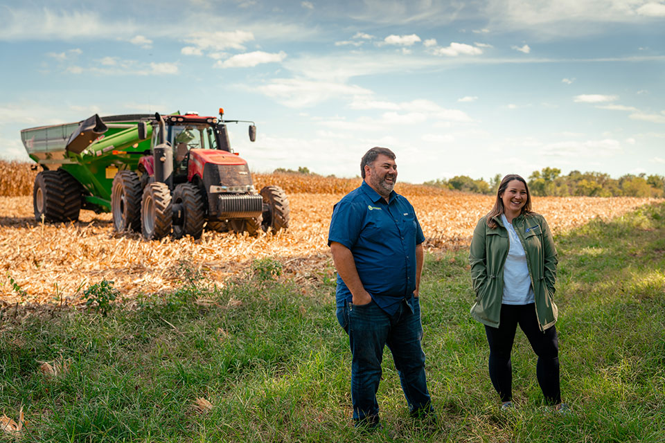 Hutchinson-268-opt Glen and Emily stand in front of their farm vehicle.