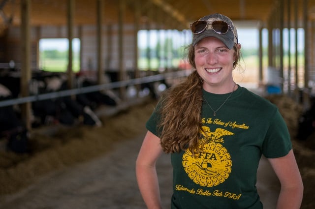 Woman in dairy shed.