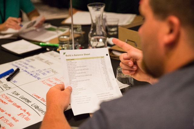 A young farmer reviews balance sheet materials.