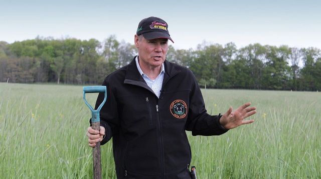 Farmer holding a shovel.