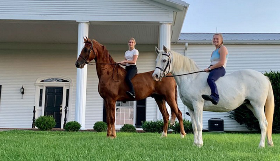 Two women riding horses.