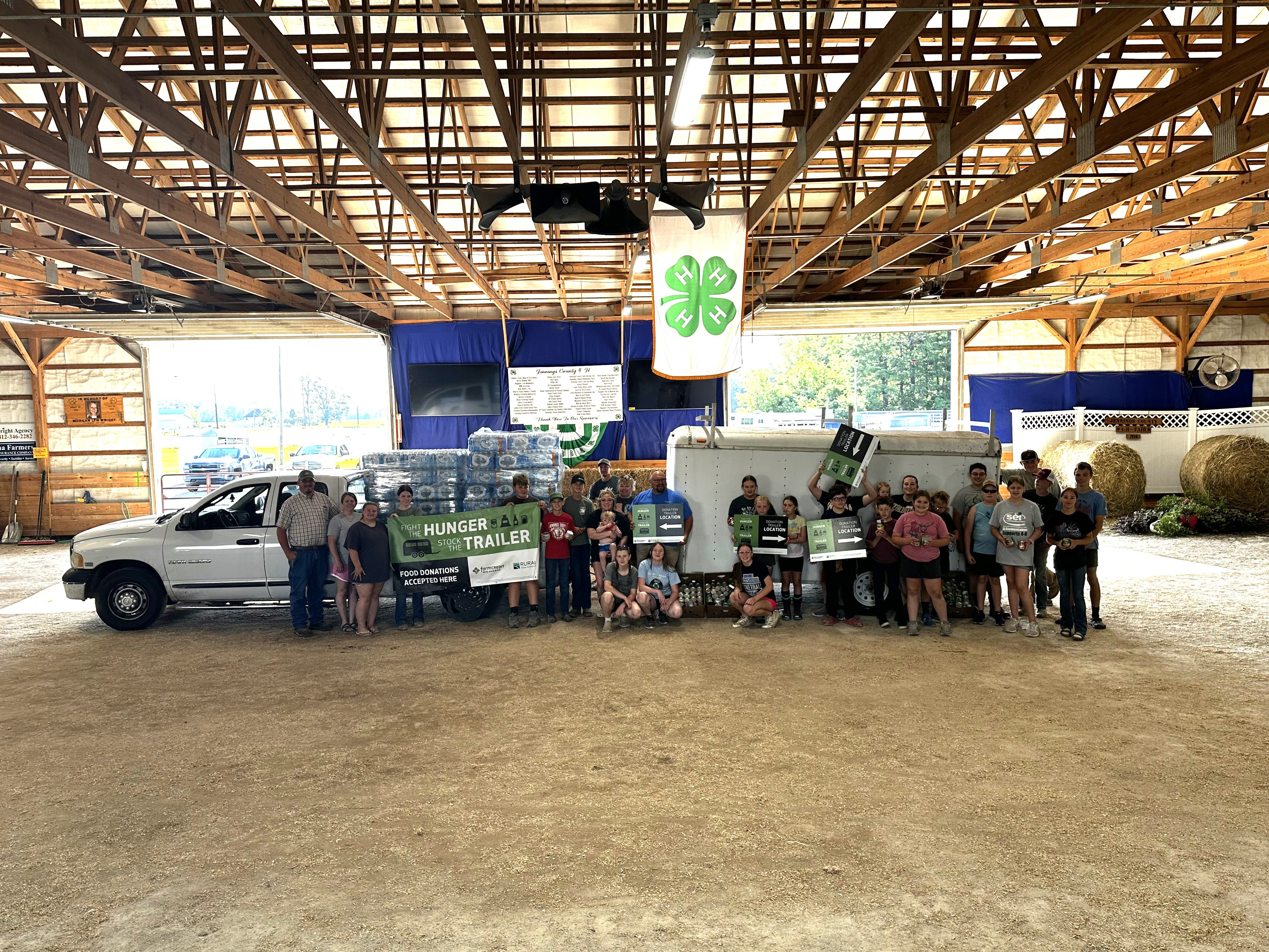 STT_Jennings County Truck and trailer of donated food with group of people standing in front