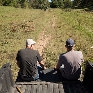Two men on a truck tailgate.