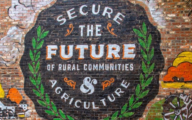 Circular mural that says secure the future of rural communities and agriculture.