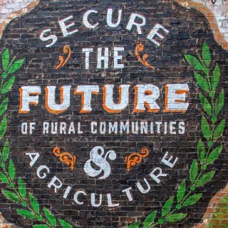 Circular mural that says secure the future of rural communities and agriculture.