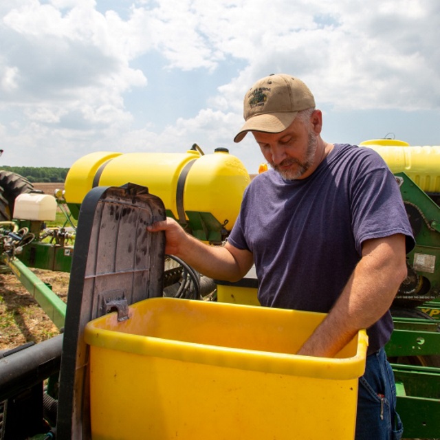 Farmer inspecting his planter.