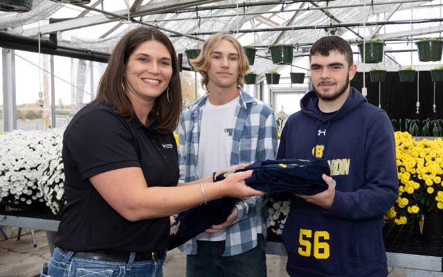 Team member presents FFA jackets to students