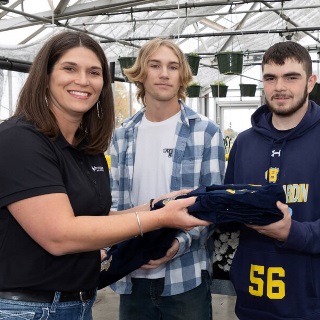 Team member presents FFA jackets to students