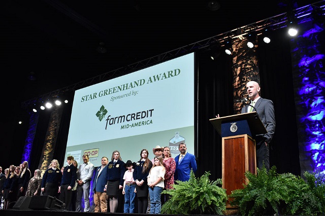 A man presents the Star Greenhand Award on stage at an FFA event.