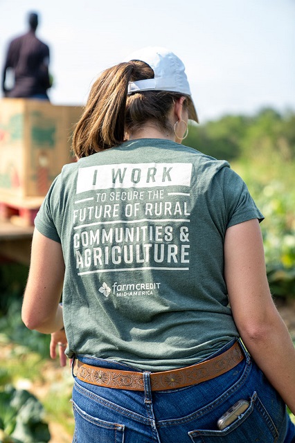 Woman's back showing the message on her t-shirt.