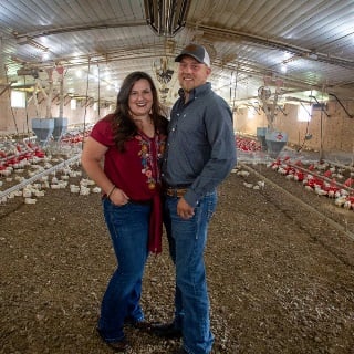 Woman and man in broiler house.