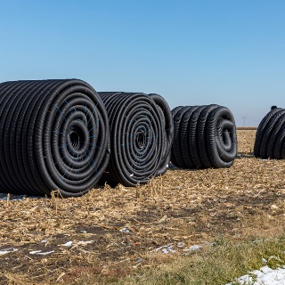 Field tiling rolls in an empty field.