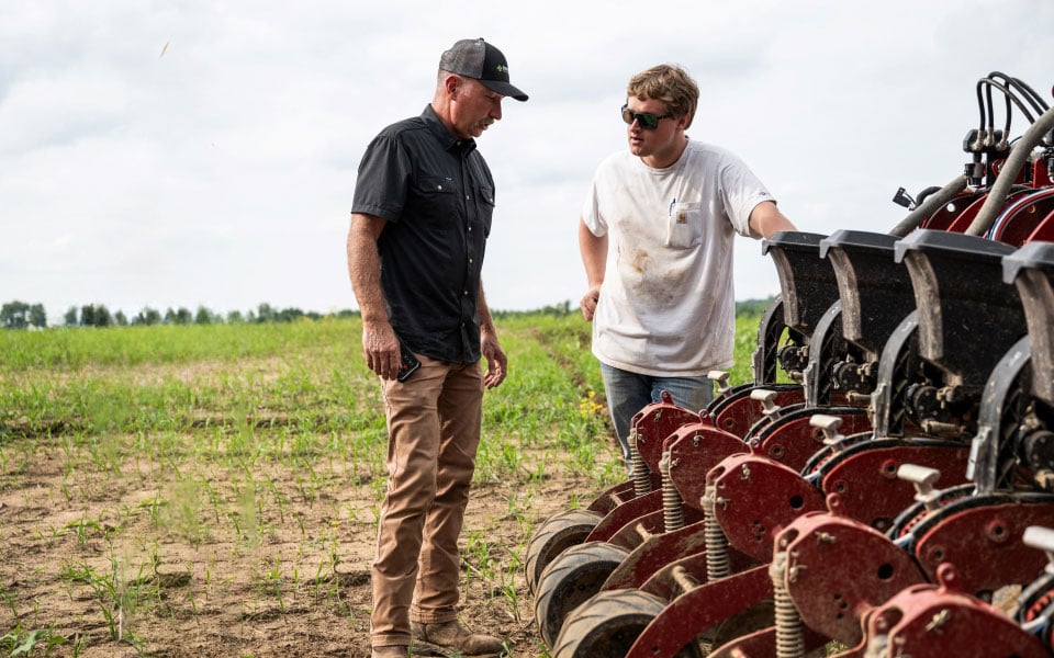 Philip Parish and Calvin Hooks troubleshoot a planter farmland financed by Farm Credit Mid-America