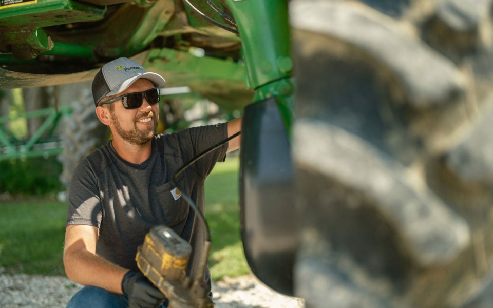 Man greasing a sprayer