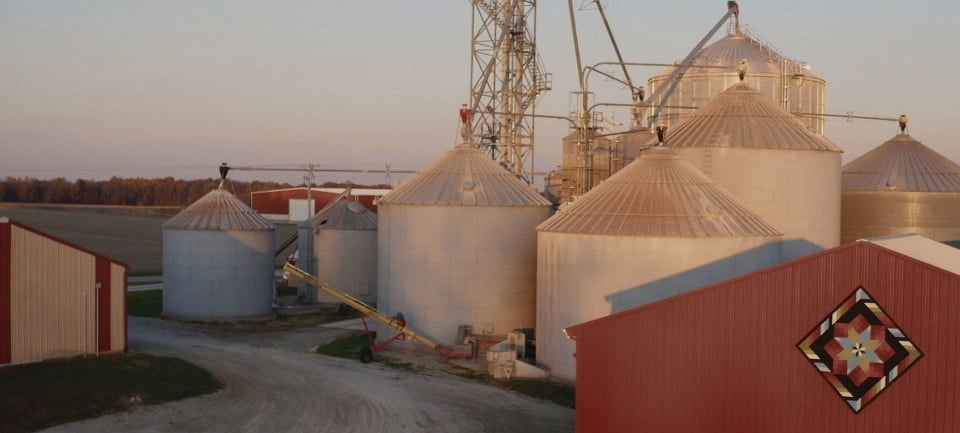 Aerial view of a barn and grain silos