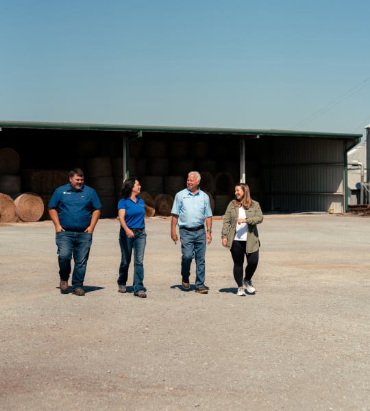Farm Credit Mid-America team members meets with family of customers on the farm