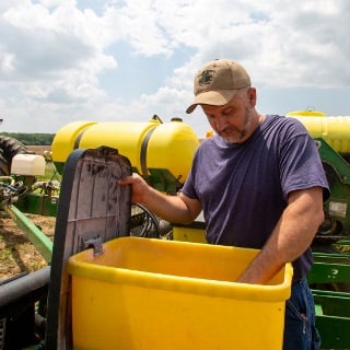 Farmer checks his planter.